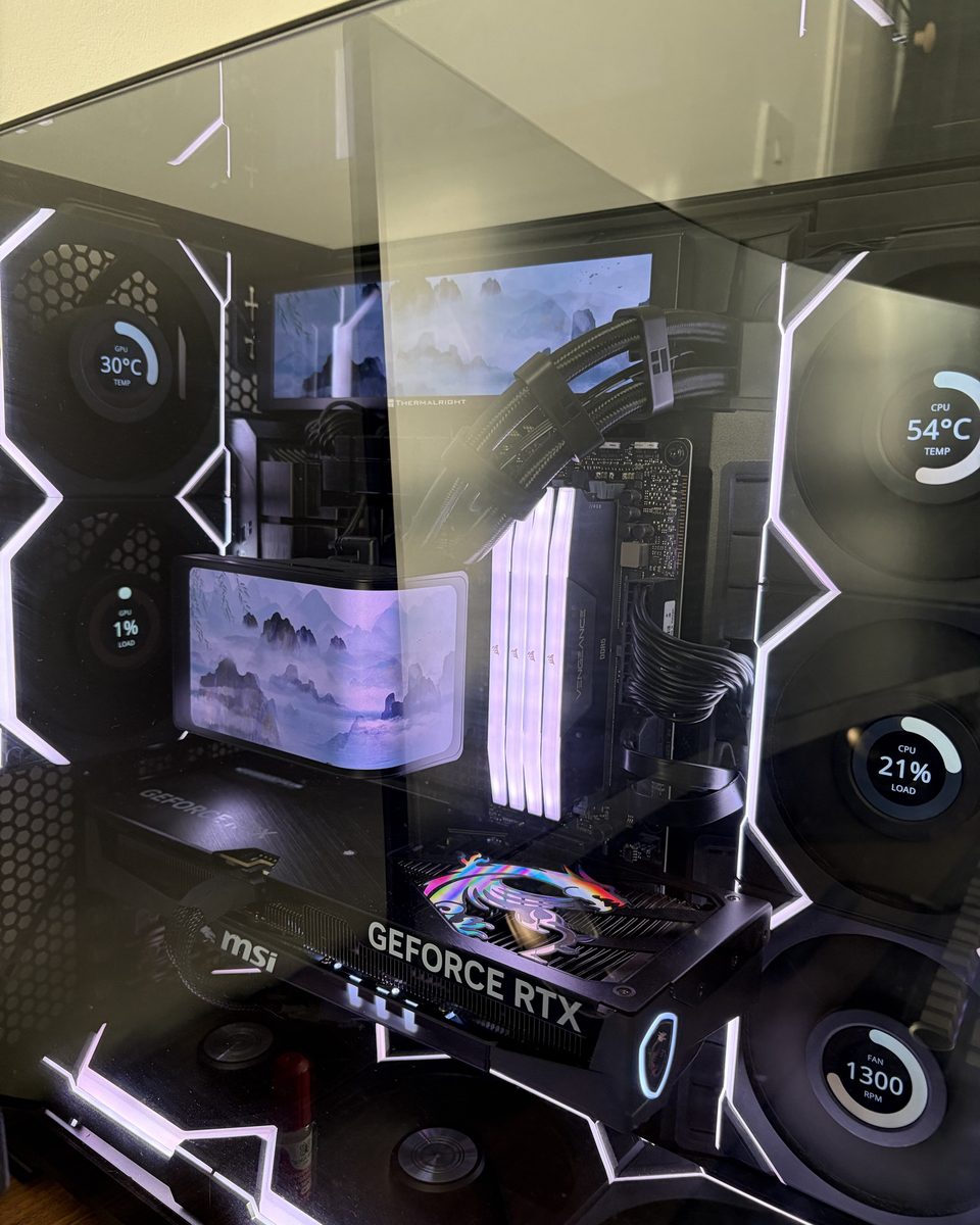 Lian Li PC build with LCD fans showing CPU and GPU temperatures
