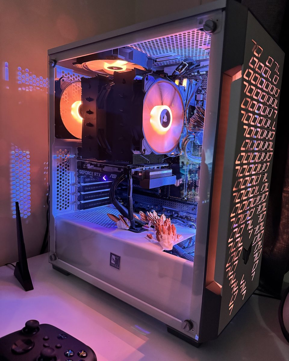 White PC build with Noctua air cooler and orange and blue lighting